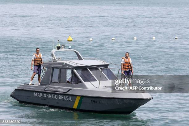 Brazilian Navy boat carrying bodies of a boat wreck, after a ferry sank off the northeastern state of Bahia, arrives at the Maritime Terminal of...