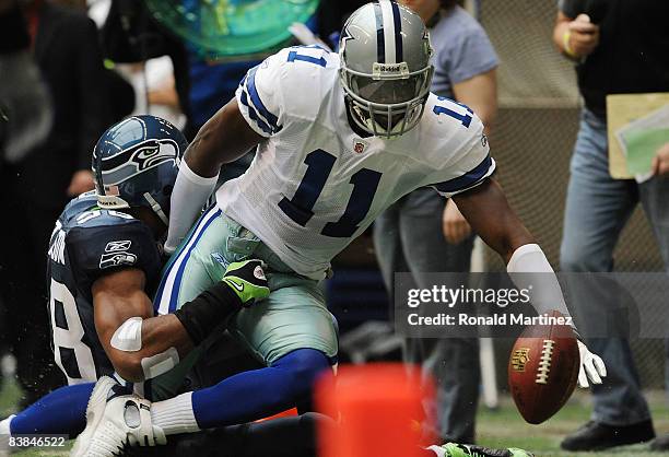 Wide receiver Roy Williams of the Dallas Cowboys is tackled by Julian Peterson of the Seattle Seahawks at Texas Stadium on November 27, 2008 in...