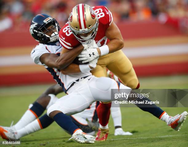 Vance McDonald of the San Francisco 49ers gets tackled after making a reception during the game against the Denver Broncos at Levi Stadium on August...