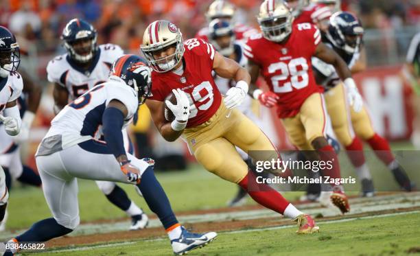 Vance McDonald of the San Francisco 49ers runs after making a reception during the game against the Denver Broncos at Levi Stadium on August 19, 2017...