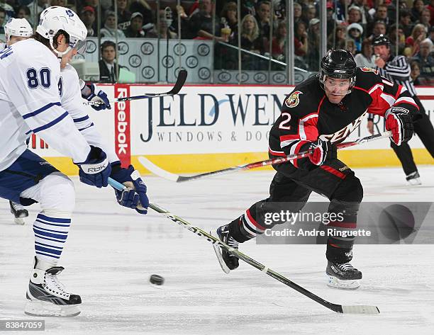 Mike Fisher of the Ottawa Senators fires a backhand shot against Nik Antropov of the Toronto Maple Leafs at Scotiabank Place November 27, 2008 in...