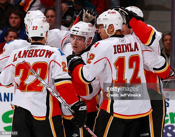 Michael Cammalleri of the Calgary Flames is congratulated by teammates after scoring during their game against the Calgary Flames at General Motors...