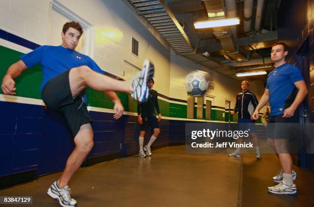 Shane O'Brien and Kyle Wellwood of the Vancouver Canucks play soccer to warm up before their game against the Calgary Flames at General Motors Place...