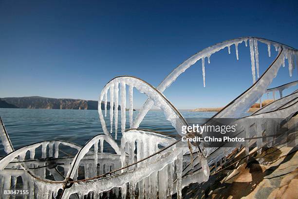 View the reservoir of the Longyang Gorge Hydropower Station is seen beyond iceglazed iron wires on November 27, 2008 in Gonghe County of Qinghai...
