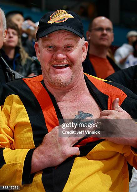 Fan shows off his Canucks tattoo over his heart during a game against the Calgary Flames at General Motors Place November 27, 2008 in Vancouver,...