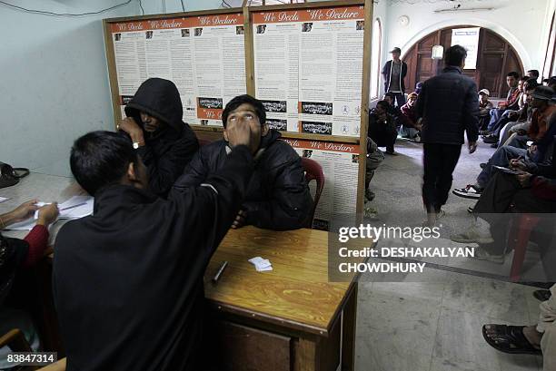 An Indian youth takes Buprenorphine under an Oral Substitution Therapy programme as People Living with HIV and AIDS wait their turn for treatment at...