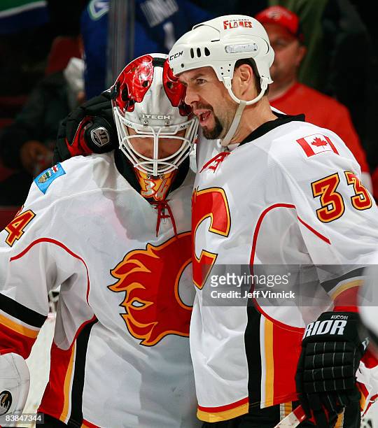 Adrian Aucoin of the Calgary Flames congratulates teammate Miikka Kiprusoff after their victory over the Vancouver Canucks at General Motors Place...