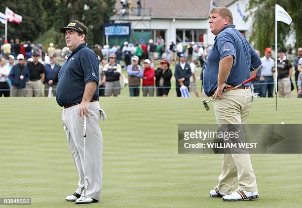 John Daly of the US and Craig Parry of Australia watch the flight of a fellow golfer's ball during the second round of the Australian Masters, being...