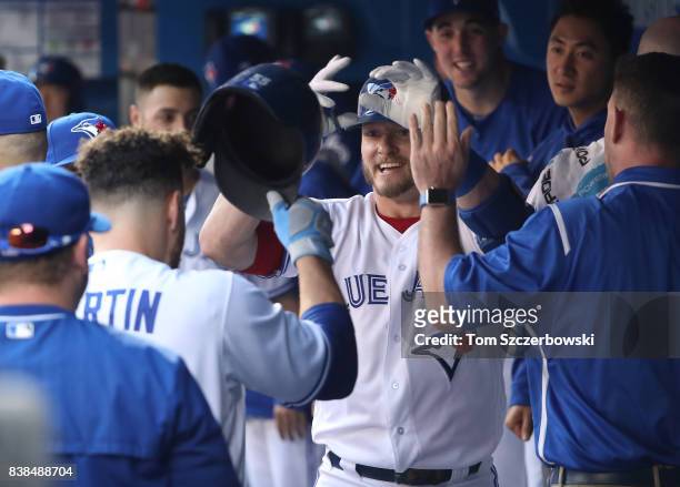Josh Donaldson of the Toronto Blue Jays is congratulated by Russell Martin after hitting a two-run home run in the third inning during MLB game...