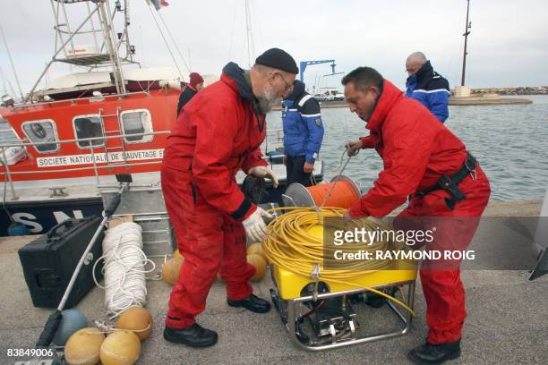 French rescue workers load an underwater robot onto a boat during searches, on November 28 in Perpignan, southern France, after an Air New Zealand...