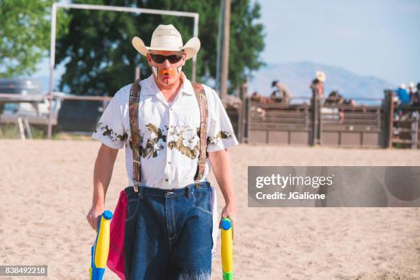 rodeo clown holding water pistols - rodeo clown stock pictures, royalty-free photos & images