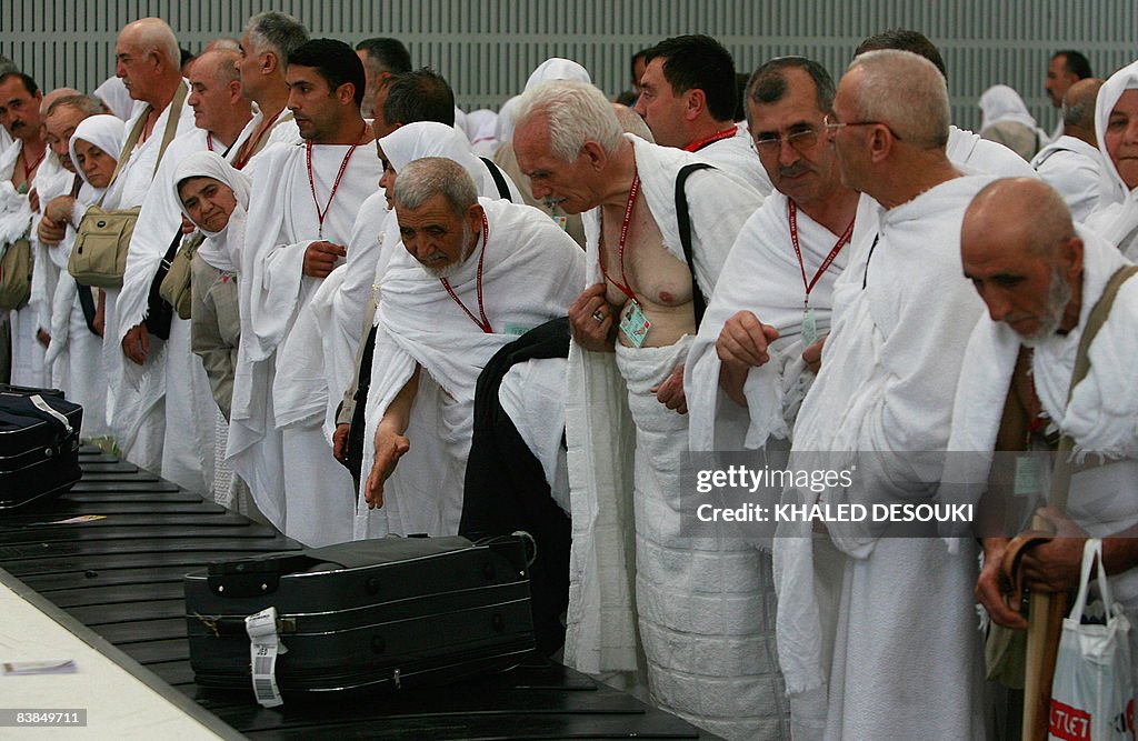 Turkish Muslim pilgrims wait next to a l