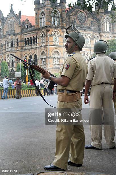 Policeman stands guard outside the Chatrapati Shivaji Terminus on November 28, 2008 in Mumbai, India. Following terrorist attacks on three locations...