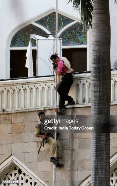 Police commando and special force jointly scale the Taj Mahal Hotel on November 28, 2008 in Mumbai, India. The city of Mumbai was rocked by multiple...