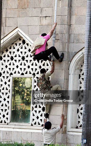 Police commando and special force jointly scale the Taj Mahal Hotel on November 28, 2008 in Mumbai, India. The city of Mumbai was rocked by multiple...
