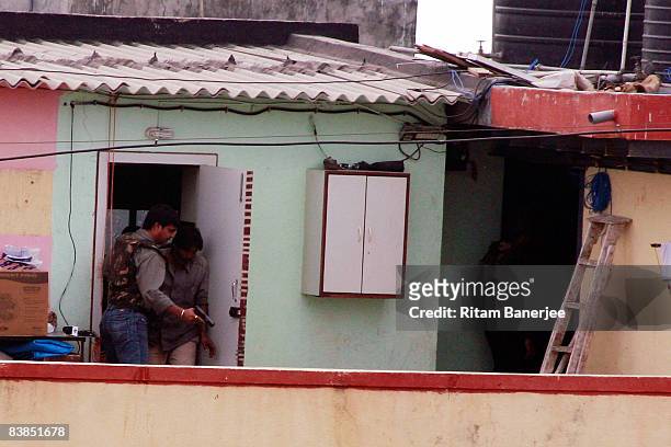 Military keep watch on the Nariman House in the Colaba Market Area on November 28, 2008 in Mumbai, India. Following terrorist attacks on three...