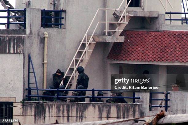 Military keep watch on the Nariman House in the Colaba Market Area on November 28, 2008 in Mumbai, India. Following terrorist attacks on three...