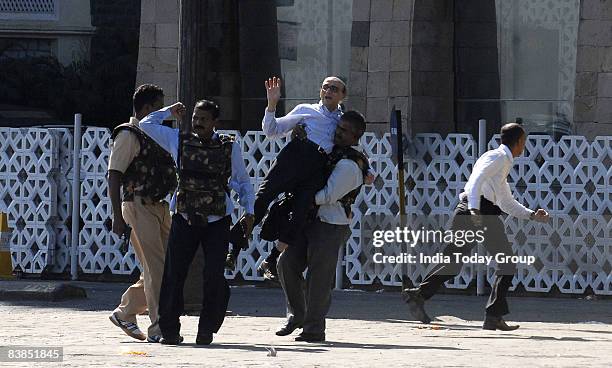 Hostage is rescued from Hotel Taj Mahal on November 28, 2008 in Mumbai, India. Following terrorist attacks on three locations in the city which have...