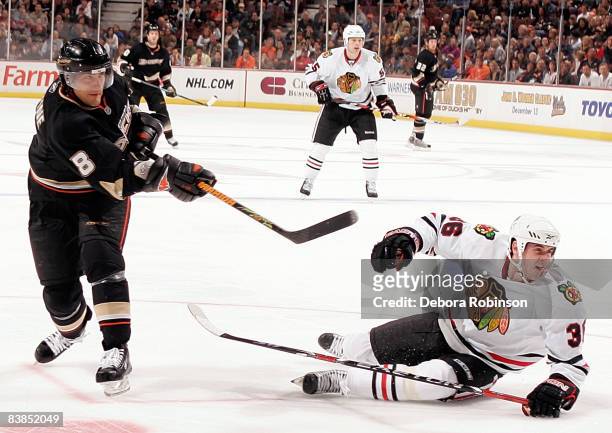 Dave Bolland of the Chicago Blackhawks falls to the ice defending against Teemu Selanne of the Anaheim Ducks during the game on November 28, 2008 at...