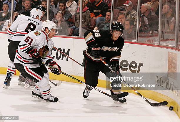 Brian Campbell of the Chicago Blackhawks defends the puck against Samuel Pahlsson of the Anaheim Ducks during the game on November 28, 2008 at Honda...