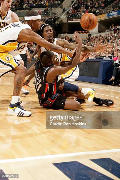 Raymond Felton of the Charlotte Bobcats battles for the ball with Marquis Daniels and T.J. Ford of the Indiana Pacers at Conseco Fieldhouse on...