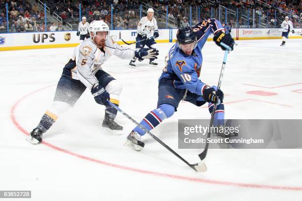 Bryan Little of the Atlanta Thrashers battles for the puck against Greg Zanon of the Nashville Predators at Philips Arena on November 28, 2008 in...