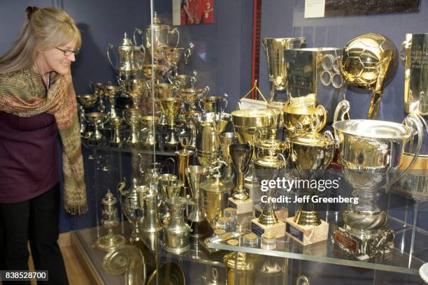 Woman looking at the trophy case at Manchester United Football Club at the Old Trafford Stadium.