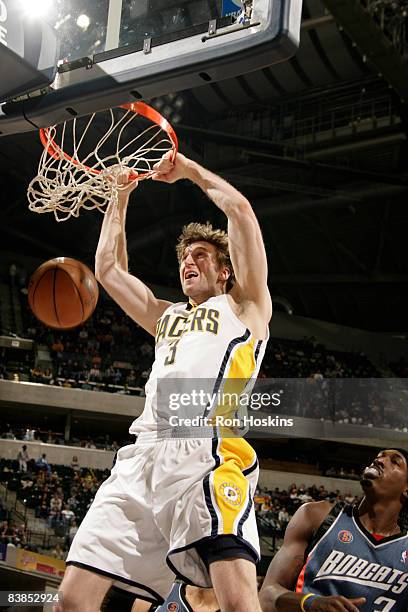 Troy Murphy of the Indiana Pacers dunks over Gerald Wallace of the Charlotte Bobcats at Conseco Fieldhouse on November 28, 2008 in Indianapolis,...