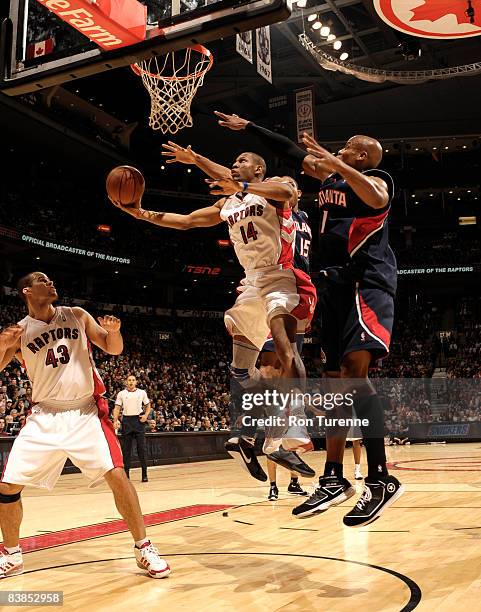 Joey Graham of the Toronto Raptors attempts a layup in front of defender Maurice Evans of the Atlanta Hawk during a game on November 28, 2008 at the...