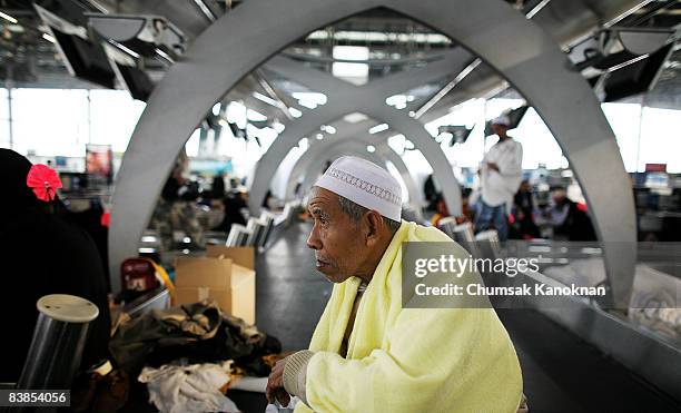 Stranded Thai muslim pilgrim sits inside Suvarnabhumi airport November 29, 2008 in Bangkok, Thailand. Nearly 100,000 passengers have missed flights...