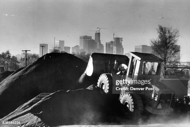 Jan 15 1981 A Brannan Sand & Gravel Co. Frontloader Scoops Up Gravel To Be Used In The Making Of Asphalt In the background is Denver's skyline, much...
