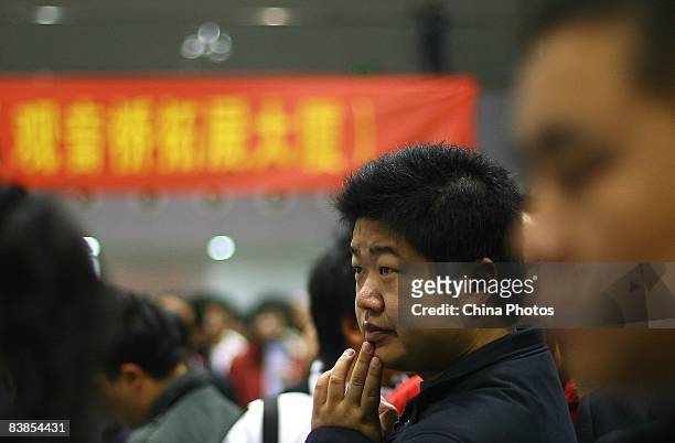 Couple of graduating university students read employment information at a job fair on November 28, 2008 in Chongqing, China. The number of Chinese...