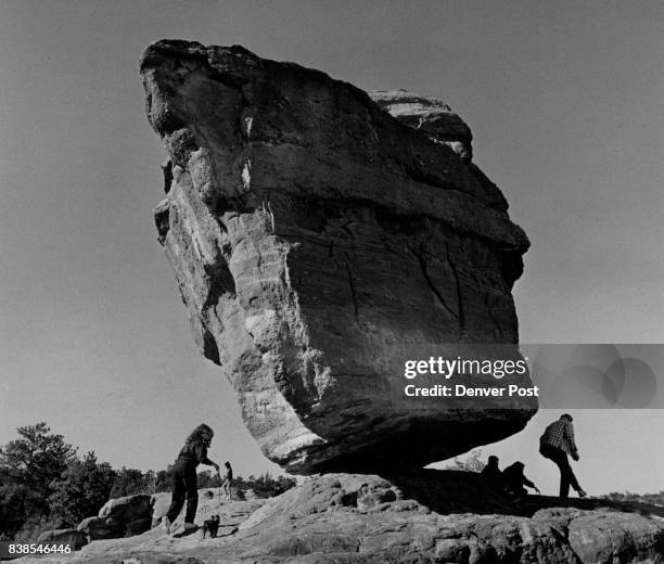 Balancing Rock in The Garden of the Gods near Colorado Springs did not tip over Tuesday. A visiting family from Wisconsin played around beneath it...