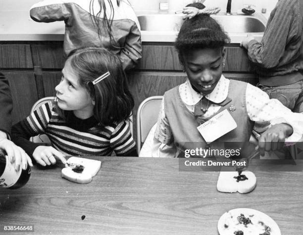 Girl Scouts become one-armed cooks while trying to experience world of the Handicapped at new Scout center. Credit: The Denver Post