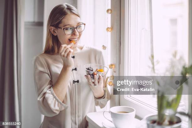 young woman at home - dried plum stock pictures, royalty-free photos & images
