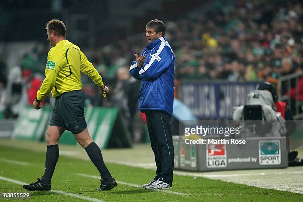 Friedhelm Funkel , head coach of Frankfurt argues with referee Helmut Fleischer during the Bundesliga match between Werder Bremen and Eintracht...