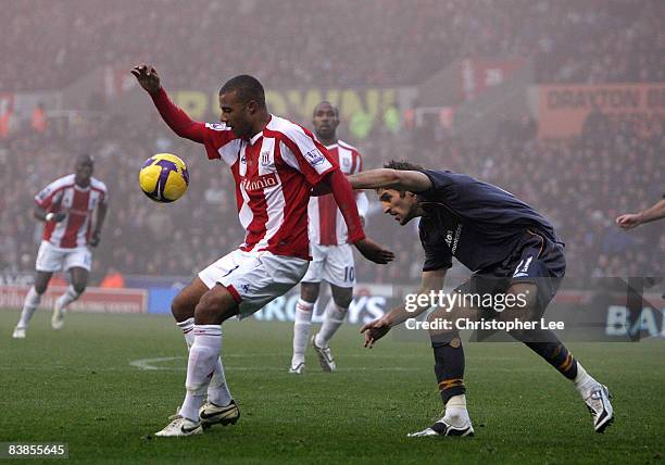 Tom Soares of Stoke City battles with Sam Ricketts of Hull during the Barclays Premier League match between Stoke City and Hull City at The Britannia...