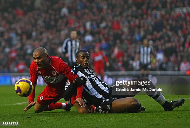 Sebastien Bassong of Newcastle United tangles in the penalty area with Afonso Alves of Middlesbrough during the Barclays Premier League match between...