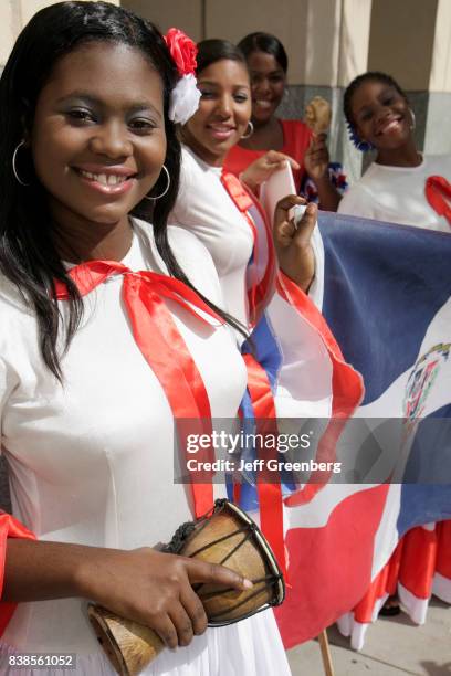 Women holding a Dominican Republic flag at the Miami Book Fair International parade.