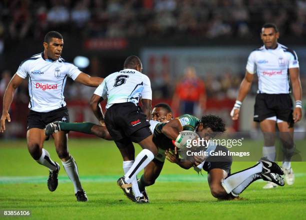 Mzwandile Stick of South Africa is tackled during the IRB Sevens Series semi-final match between South Africa and Fiji at the Sevens Stadium on...