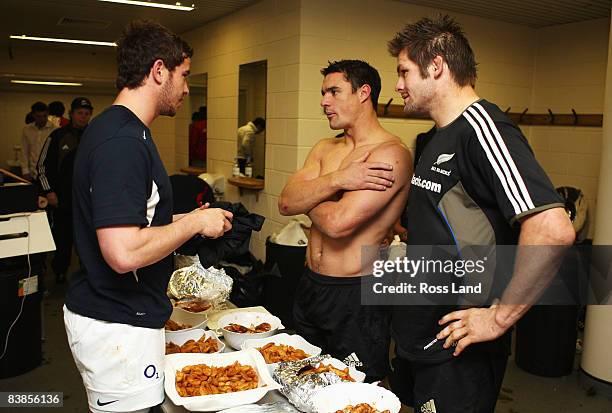 Danny Cipriani of England talks to Dan Carter and Richie McCaw of New Zealand in the changing room after the Investec Challenge match between England...