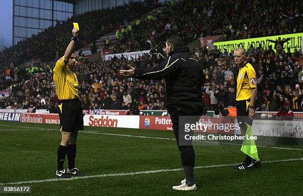 Dean Windass of Hull City is booked by referee Keith Stroud for blocking the throw in by Rory Delap of Stoke during the Barclays Premier League match...
