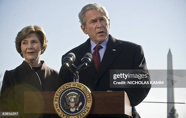 President George W. Bush makes a statement, with his wife Laura by his side, on the attacks in Mumbai upon his return to the White House in...