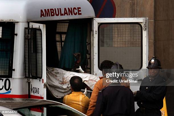 Indian police are getting a dead body into an ambulance outside the Taj Mahal Palace & Tower Hotel following an armed siege on November 29, 2008 in...