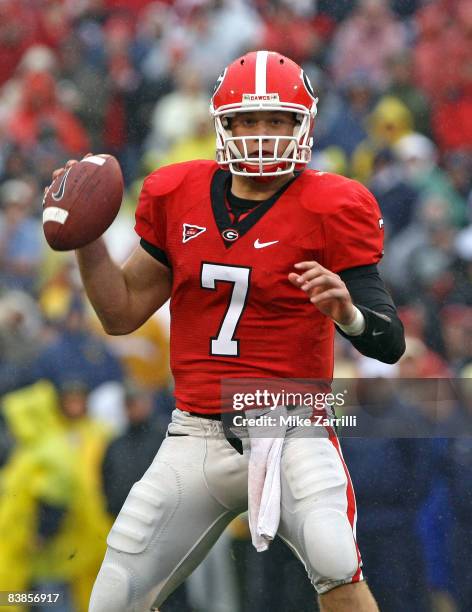 Quarterback Matthew Stafford of the Georgia Bulldogs looks downfield to pass during the game against the Georgia Tech Yellow Jackets during the game...