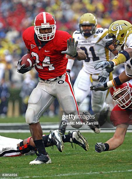 Running back Knowshon Moreno of the Georgia Bulldogs breaks through the line of scrimmage during a rushing attempt during the game against the...