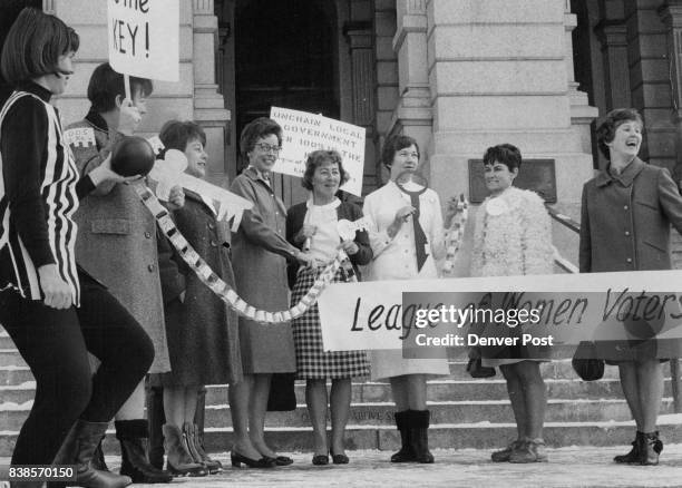 League of Women Voters Backs Reform "Ball and chain" bearers from the League of Women Voters of Colorado gather on Colorado Statehouse steps Tues-day...