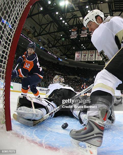 Goaltender Dany Sabourin and defenseman Rob Scuderi of the Pittsburgh Penguins stops Josh Bailey of the New York Islanders on November 26, 2008 at...