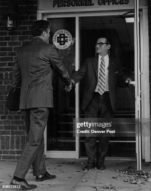 Osborn, right, of Gardner-Denver greets Walt Hume as he arrives for a followup call at the general offices of the company's Denver Division at 1727...