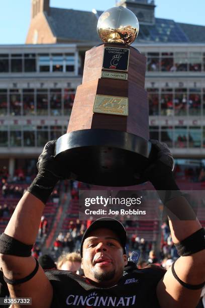 Khalil El-Amin of the Cincinnati Bearcats hoists the championship trophy after the game against the Syracuse Orange at Nippert Stadium on November...